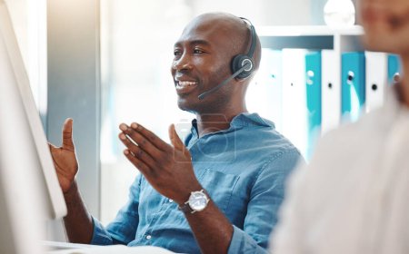 Customer service, consultant and contact us for our call center employees to support in helping you with a loan. African Fintech insurance agent working at a computer desk happy to give you advice.