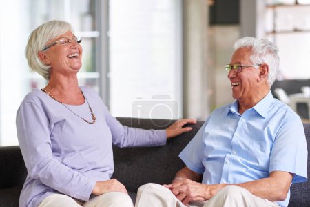 Photo for Be that cute old couple. a senior couple sitting together while laughing humorously - Royalty Free Image