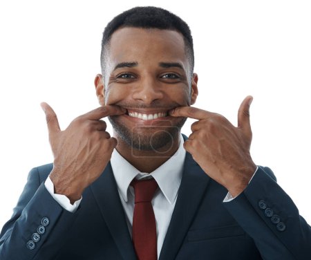 Photo for Keeping up positive appearances. A young businessman stretching his mouth into a smile while isolated on white - Royalty Free Image