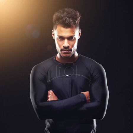 Photo for Train insane or remain the same. Studio shot of a fit young man isolated on black - Royalty Free Image