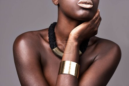 Emphasising her love for bold jewellery. Cropped studio shot of a beautiful semi-dressed woman wearing jewelry