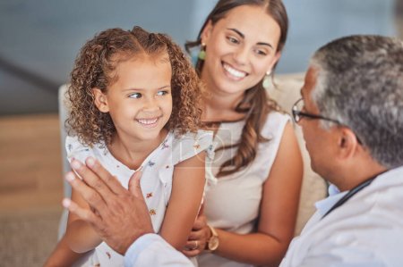 Child doctor, pediatrician and high five with happy girl patient with mom parent during health checkup with healthcare insurance. Latino kid and woman celebrate with man gp in Puerto Rico hospital.