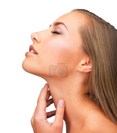 She takes skincare seriously. Studio shot of a beautiful brunette woman isolated on white