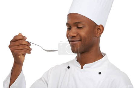 Photo for Just a taste to see if its ready. An african chef tasting his food before serving it - Royalty Free Image