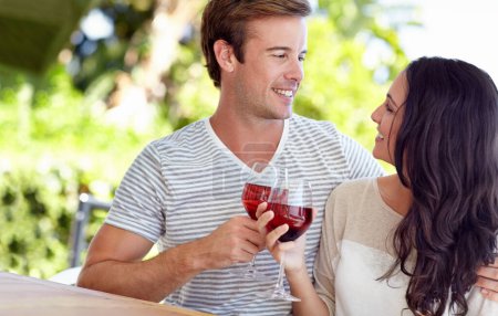 Photo for Cheers to us. A young couple drinking a glass of wine on their patio - Royalty Free Image