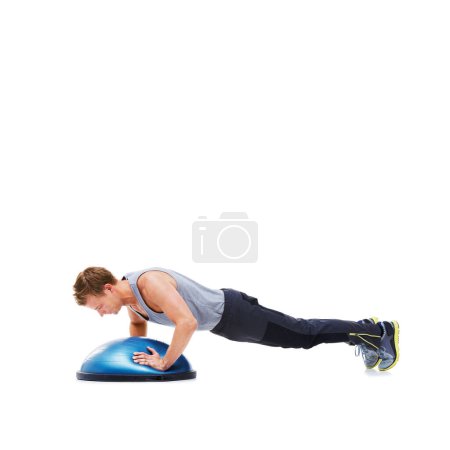 Photo for He understands the importance of exercise. A handsome young man using a bosu-ball for an upper body workout - Royalty Free Image