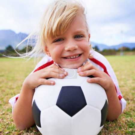 Photo for Waiting for the coach. Portrait of a young girl lying on a soccer field - Royalty Free Image