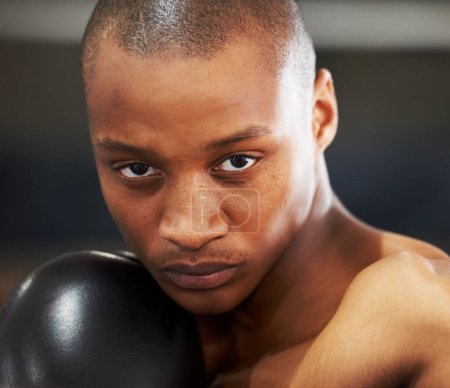 Resolved to succeed. A young boxer with determination and focus in his eyes