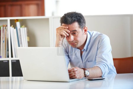 Photo for Theres no avoiding it. a stressed out businessman using a laptop - Royalty Free Image