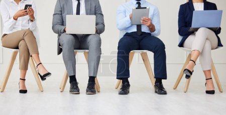 Unknown group of diverse businesspeople waiting for interview and using technology. Team of applicants sitting together. Professional candidates in line for job opening, vacancy and office opportunit. mug #646263286