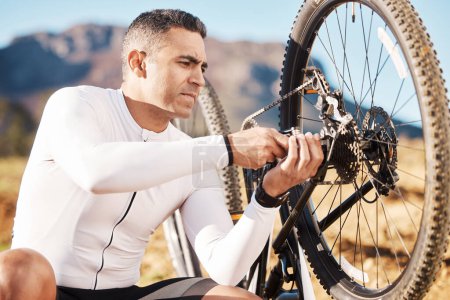Photo for Cycling, repair and wheel with man and focus for sports, wellness and fitness training. Insurance, safety and tire change with cyclist fixing mountain bike on trail for broken, puncture and check. - Royalty Free Image