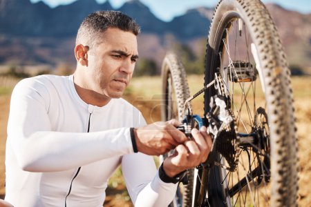Photo for Cycling, fixing and wheel with man in nature for sports, wellness and fitness training. Insurance, safety and tire change with cyclist and repair mountain bike on trail for broken, puncture and check. - Royalty Free Image