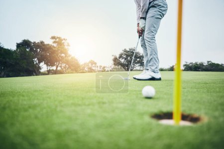 Sports, golf hole and man with golfing club on course ground for game, practice and training for competition. Professional golfer, grass and male athlete hit ball for winning, score or tee stroke.