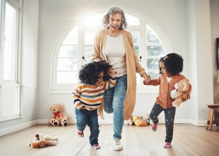 Photo for Hopscotch, grandmother and children play in home having fun, enjoy games and balance together in bedroom. Happy family, entertainment and grandma with kids for jumping, playing and numbers activity. - Royalty Free Image