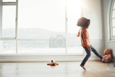 Photo for Hopscotch, happy and girl play in home having fun, enjoying games and relaxing in bedroom. Childhood mockup, entertainment and girl with copy space playing, jumping and balance for numbers activity. - Royalty Free Image