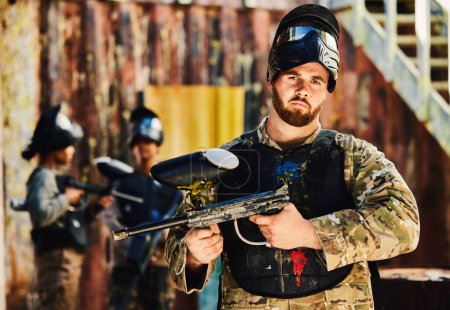 Photo for Paintball, serious or portrait of man with gun in shooting game playing in action battlefield mission. War, hero or focused soldier with army weapons gear in survival military challenge competition. - Royalty Free Image
