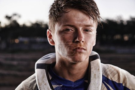 Photo for Passion comes with a bit of dirt. Portrait of a dirtbike race standing in his race gear - Royalty Free Image