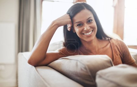 Photo for Nothing inspires happiness like a comfy day on the couch. a happy young woman enjoying a relaxing day on the sofa at home - Royalty Free Image