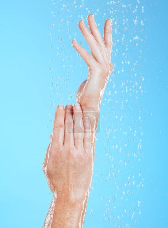 Photo for Woman, hands and water drops, hygiene and handwashing, skincare and moisture on blue background. Natural, sustainability and wellness with eco friendly dermatology, shower and cleaning for health. - Royalty Free Image