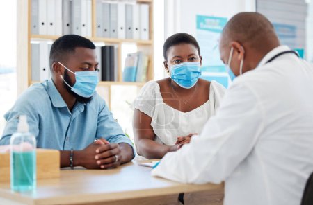 Photo for Covid, medicine and doctor consulting a black couple in a hospital for wellness, insurance or treatment. Medical, health or trust with a healthcare professional talking to a man and woman in a clinic. - Royalty Free Image