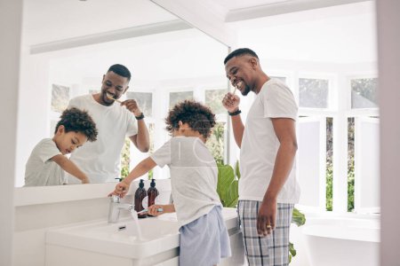 Brushing teeth, father smile and healthy morning routine in a bathroom sink with a dad and child. Hygiene, kid and dada together in a house with toothbrush and youth doing self care for dental.