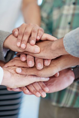 Photo for United in their success. a group of coworkers with their hands in a huddle - Royalty Free Image