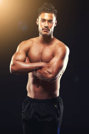 Photo for You can see he never skips a gym session. Studio shot of a fit young man isolated on black - Royalty Free Image