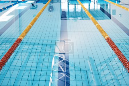 Photo for Swimming, lane and water at an indoor pool for sports, recreation and weekend fun. Empty, training and a rows for competition, sport race or practice cardio for athletes or leisure activities. - Royalty Free Image