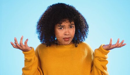 Face, confused and unsure black woman in studio, pensive and dont know gesture on blue background. Doubt, portrait and girl with decision, why or emoji on mockup, product placement or isolated.