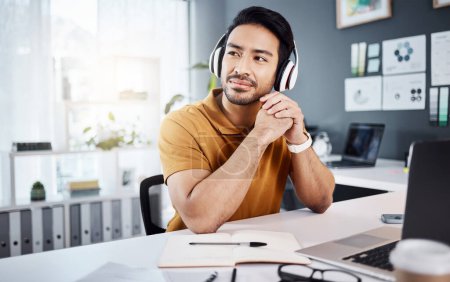 Photo for Business man, thinking and headphones to listening to music, audio or podcast. Asian male entrepreneur at desk with headset to think of ideas, strategy and plan for growth development and future. - Royalty Free Image