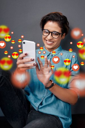 Photo for Smile, love emoji or happy woman with a phone for communication, social media texting or online dating. Graphic overlay or relaxed girl on mobile app website or digital network with heart emoticons. - Royalty Free Image
