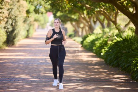 Photo for Music, fitness or woman running in park training, cardio exercise or full body workout for marathon. Sports, runner or healthy girl athlete exercising on jog streaming audio or radio song in nature. - Royalty Free Image