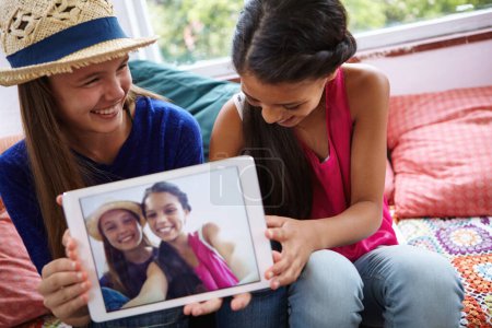 Photo for Memories that will last forever. teenage friends taking a selfie together on a digital tablet - Royalty Free Image