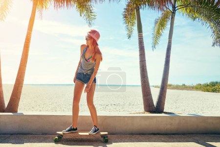 Photo for Dont let them tell you what you cant do. a young woman hanging out on the boardwalk with her skateboard - Royalty Free Image