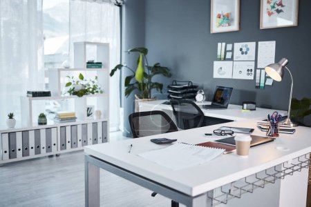 Empty office, interior and workspace with furniture, table and professional layout in startup agency. Background of modern workplace, business building and room in company, job venue or minimal setup.