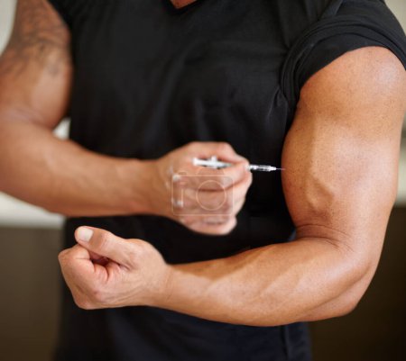 Arm, steroids and syringe with a bodybuilder man using a needle for a bicep muscle injection closeup. Fitness, health and testosterone with a male athlete or sports person injecting illegal substance.