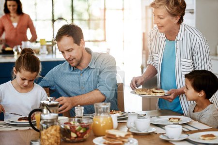 Photo for Breakfast is always served with a good helping of love. a multi generational family enjoying breakfast together at home - Royalty Free Image