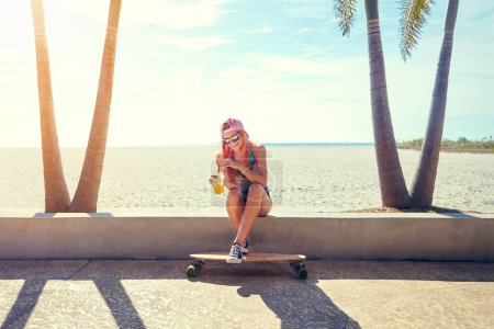 Photo for Its not fun until you go longboarding. a young woman hanging out on the boardwalk with her skateboard - Royalty Free Image