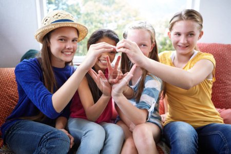 Photo for Close or apart best friends forever in your heart. a group of teenage friends using their hands to make the shape of a heart - Royalty Free Image
