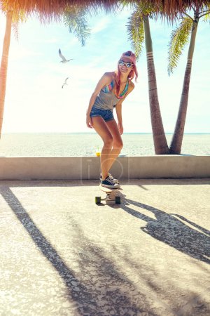 Photo for Theres nothing better than being out skating. a young woman hanging out on the boardwalk with her skateboard - Royalty Free Image