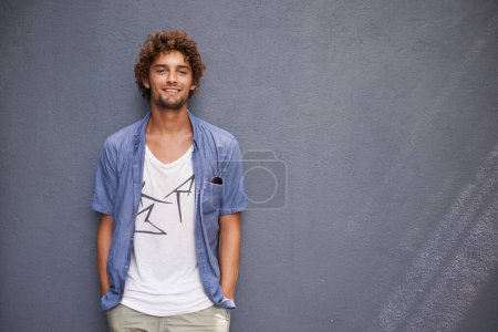 Photo for Happy, smile and portrait of a man by a wall with mockup space with a casual, cool and stylish outfit. Happiness, positive and handsome male model with trendy style or fashion with gray background - Royalty Free Image