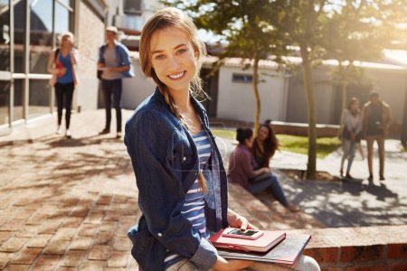 Photo for I love the college life. Portrait of a young student sitting on campus - Royalty Free Image