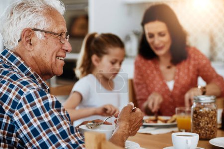Photo for Making it a grand breakfast. an elderly man enjoying breakfast with his family at home - Royalty Free Image