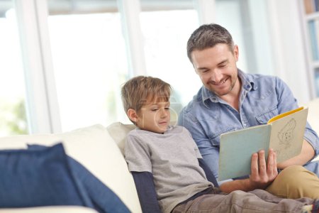 Bonding over their favorite book. a father reading a story to his son at home