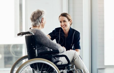 Photo for Making sure that my patient is comfortable. a female nurse caring for a senior woman in a wheelchair - Royalty Free Image