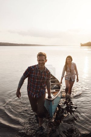 Photo for Happy that we had this getaway. a young couple coming from a canoe ride on the lake - Royalty Free Image