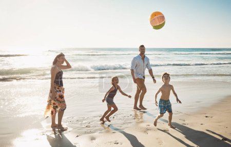 Photo for Family and beach just go together. a family of four spending the day at the beach - Royalty Free Image