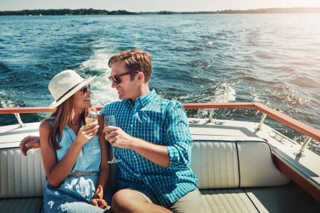 Photo for Live life in the lavish lane. a young couple having champagne on a boat ride - Royalty Free Image