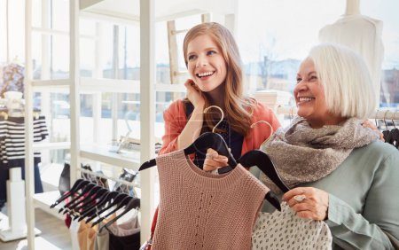 Photo for Take your mom shopping for once. a mother and daughter shopping in a clothing boutique - Royalty Free Image