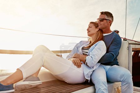 Photo for Love is keeping your marriage on honeymoon. a couple enjoying a boat cruise out on the ocean - Royalty Free Image